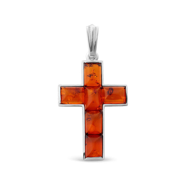 Cross-shaped pendant with amber stones on a white background