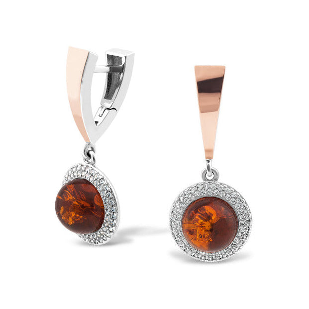 Pair of amber stone earrings with silver and rose gold accents on a white background