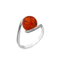 Silver ring with a large amber stone on a white background
