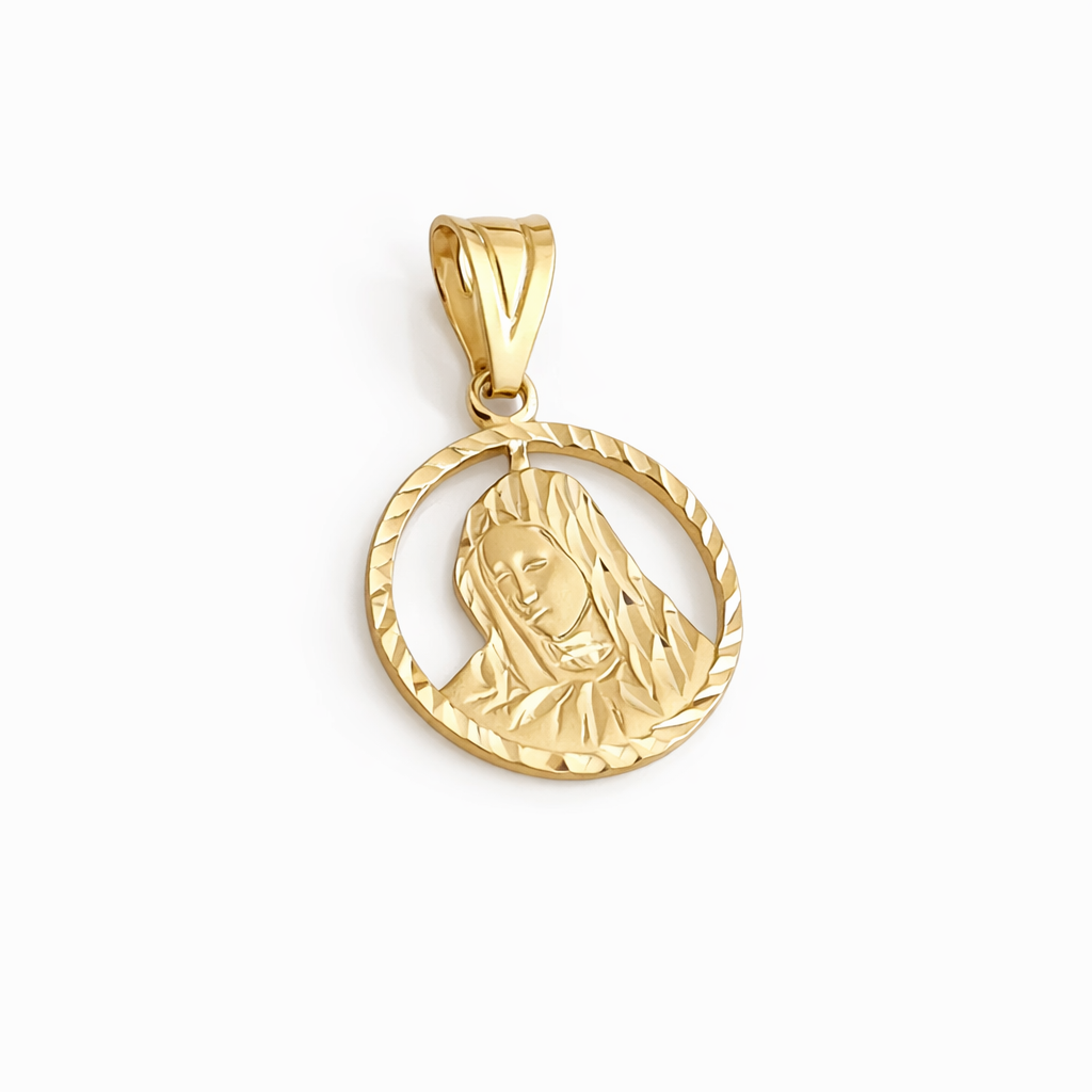 Gold pendant with a face design on a white background