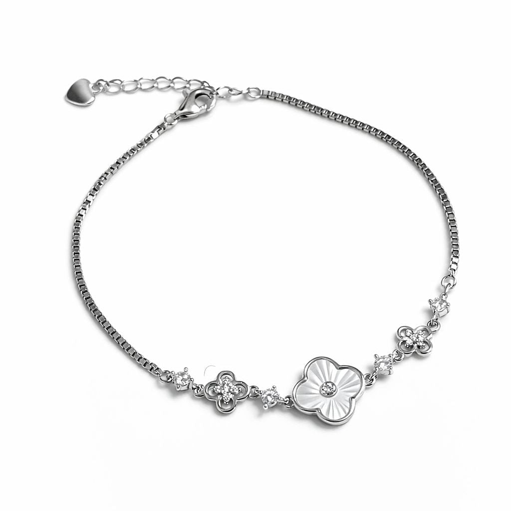 Silver bracelet with floral design on a white background