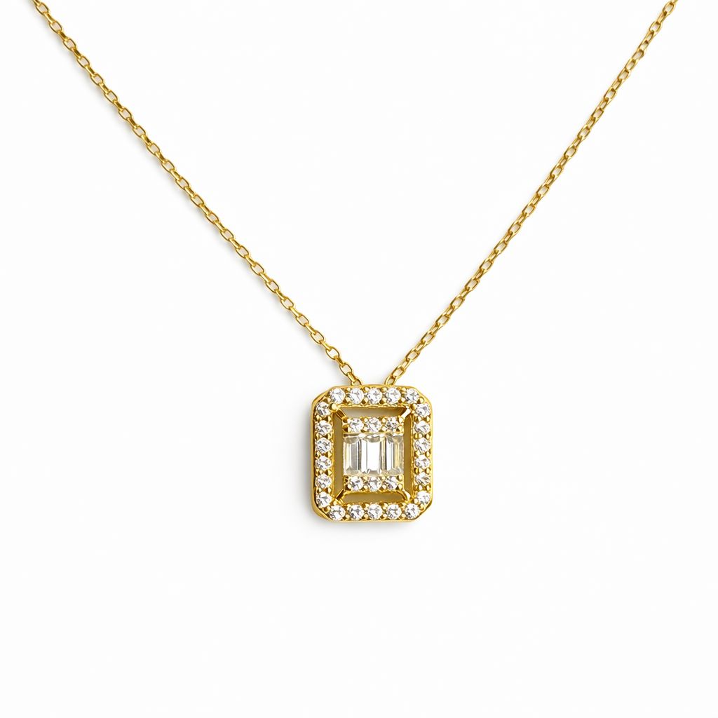 Gold necklace with cubic zirconia pendant on a white background