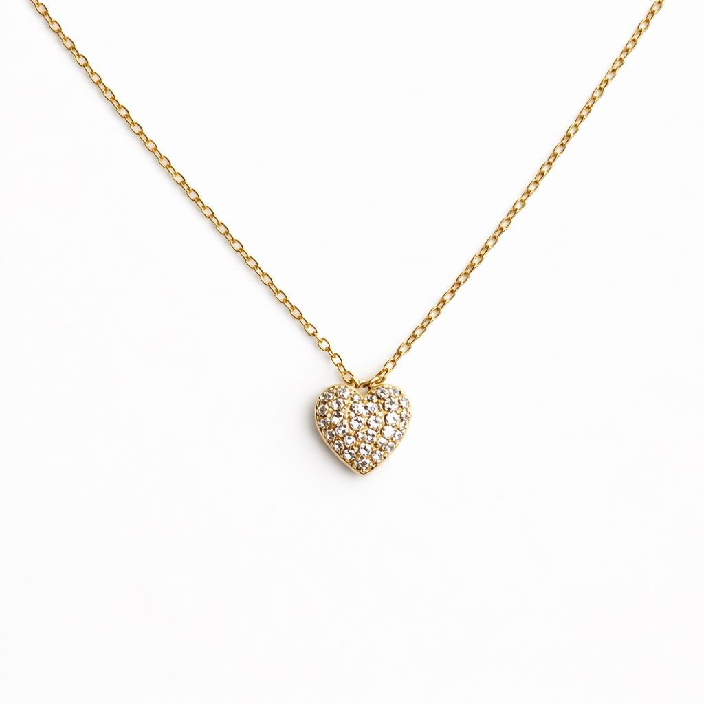 Gold heart necklace with cubic zirconia on a white background
