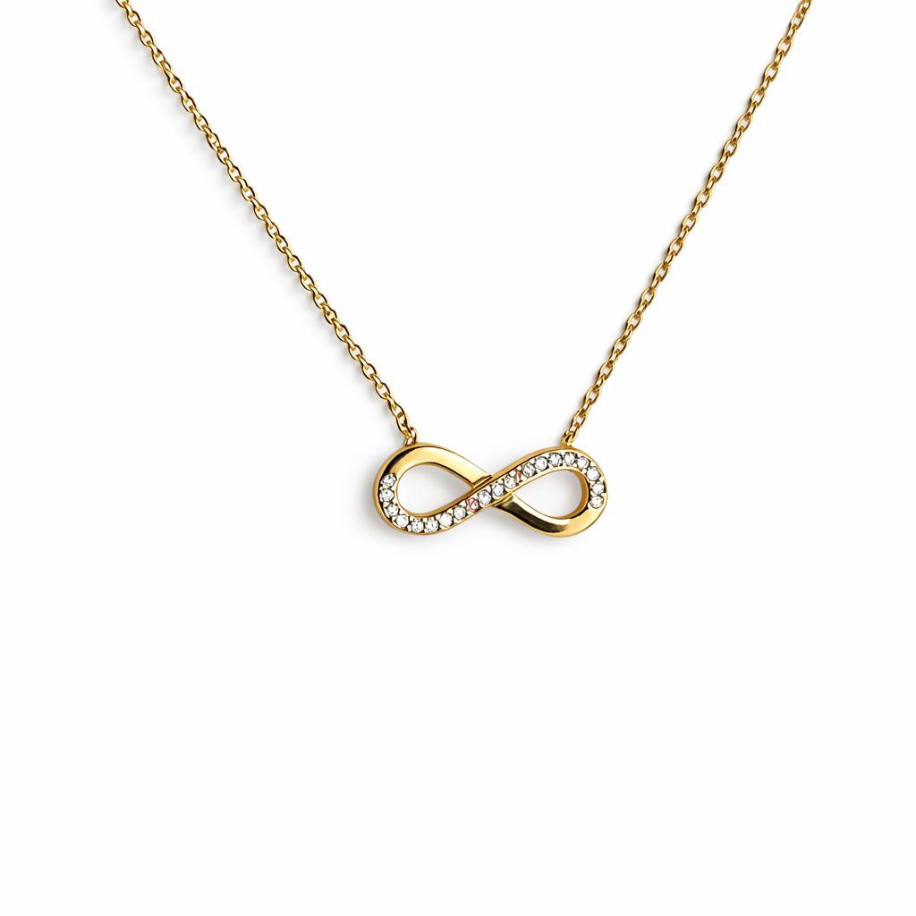 Gold infinity necklace with cubic zirconia on a white background