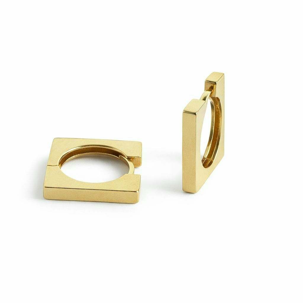 Yellow gold hoop earrings on a white background